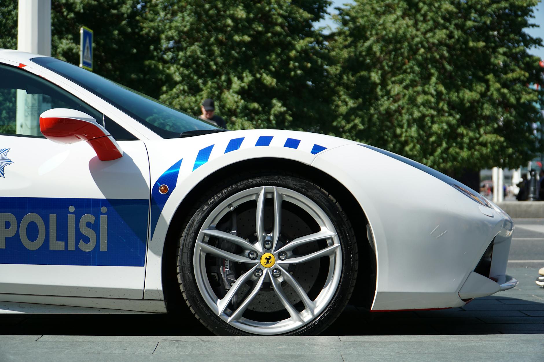 technician checking tire pressure on a Ferrari 488 GTB