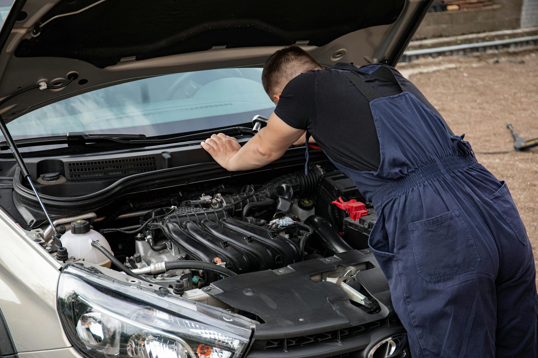 camper van owner checking oil level and fluids under the bonnet