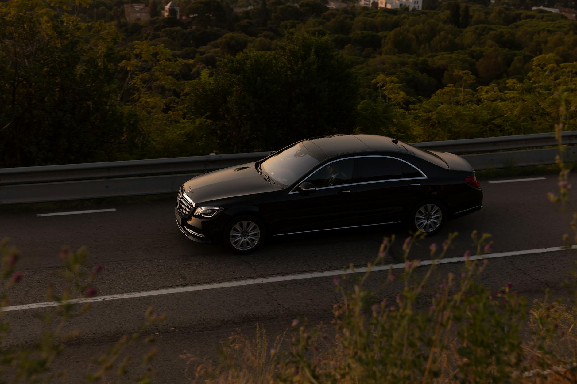 driver testing Mercedes Benz Clase C on winding road