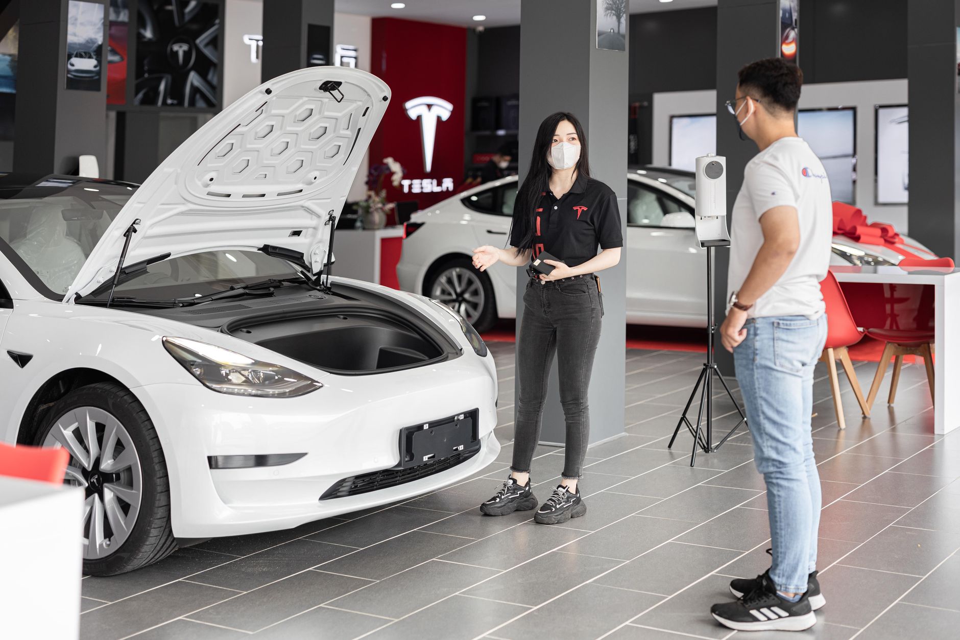 mechanic checking electric motor tesla model 3