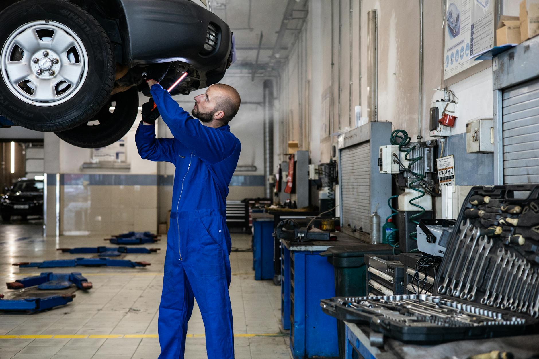 technician inspecting brake pads bmw i3